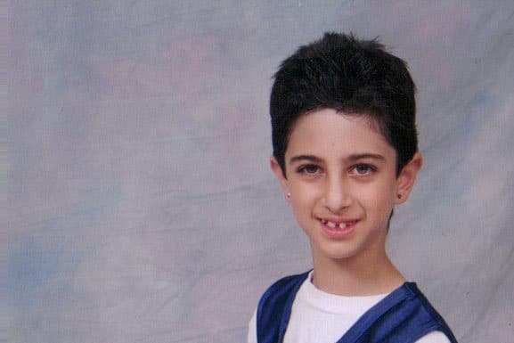 I Was Bullied: Lessons from the Bottom of the Social Hierarchy 7 year old girl with short hair wearing basketball uniform and holding a basketball kneels for a photo. She began to bullied a lot around this time.