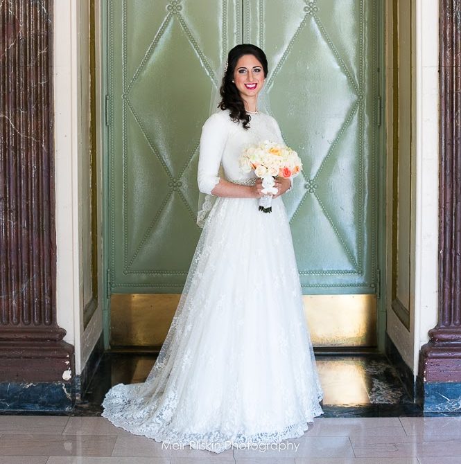 Davida posing in her wedding dress on her wedding day.