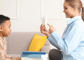 Childhood Speech Disfluencies: Is My Child Stuttering? A young boy and his language teacher