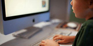 Huggy Wuggy and Kissy Missy: YouTube Characters You Need to Know About Now hands of a child on a keyboard and in front of a computer.