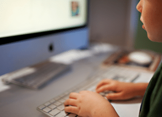 Huggy Wuggy and Kissy Missy: YouTube Characters You Need to Know About Now hands of a child on a keyboard and in front of a computer.