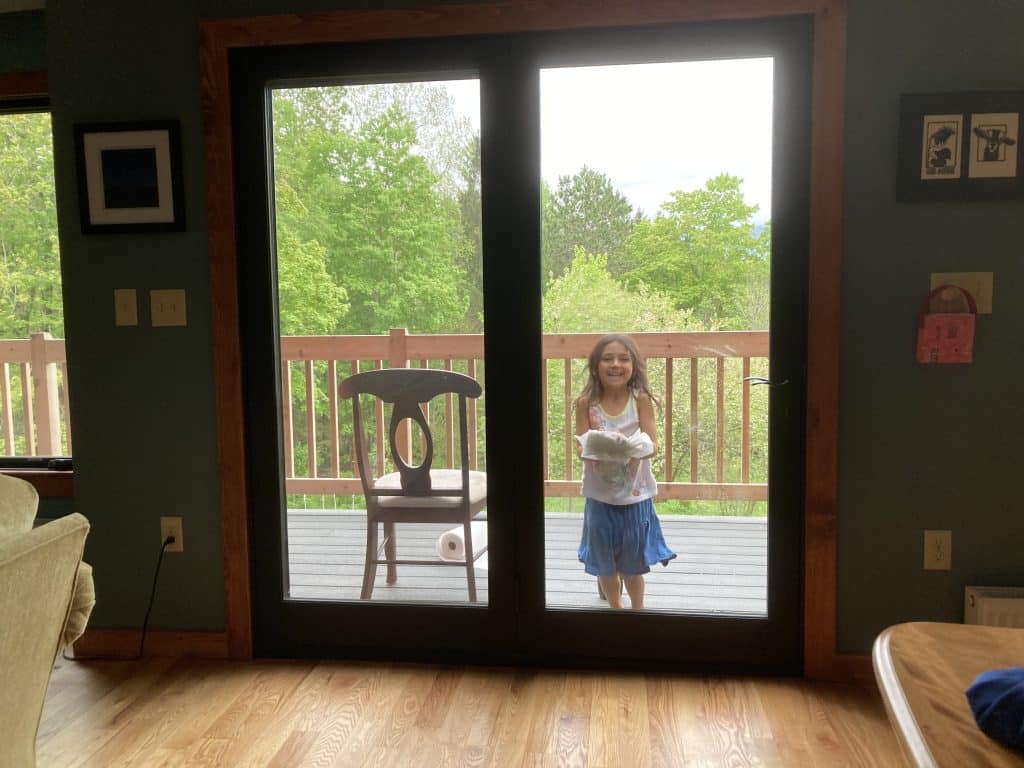 child happily washing windows