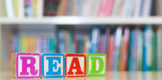 12 Summer Children’s Books to Enjoy with Your Family blocks spell out the word read in front of book shelves