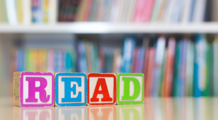 12 Summer Children’s Books to Enjoy with Your Family blocks spell out the word read in front of book shelves