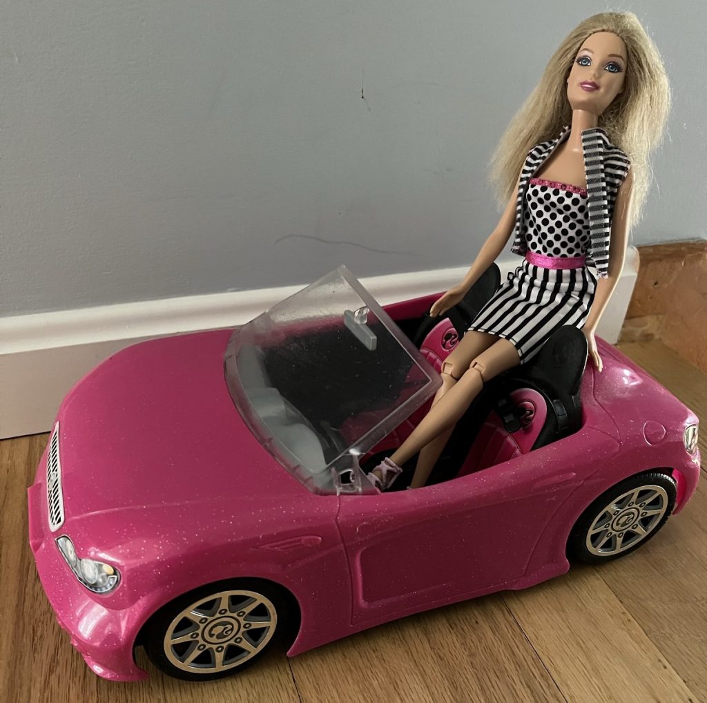Barbie in a convertible.