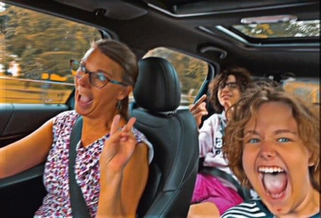 family making faces in the car