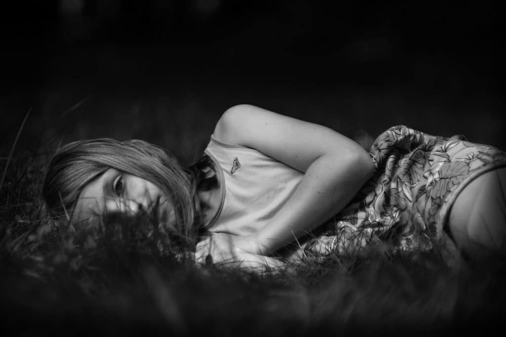 girl lying in the grass