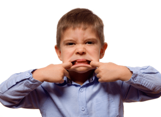 5 Ways I’ve Applied First Time Parenting Lessons to Baby Number Two Young boy sticking his tongue out.