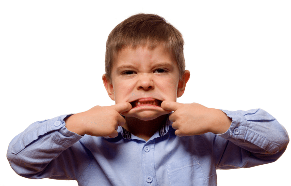 5 Ways I’ve Applied First Time Parenting Lessons to Baby Number Two Young boy sticking his tongue out.