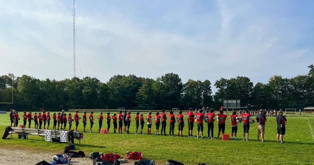 Youth football team lined up before a game. Photo by Dennis Healy, used with permission.