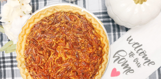 This image shows a baked pecan pie on a table with a tea cloth.