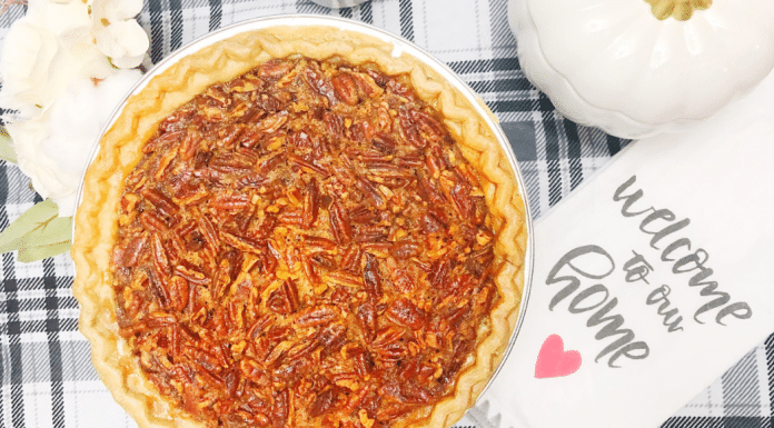 This image shows a baked pecan pie on a table with a tea cloth.