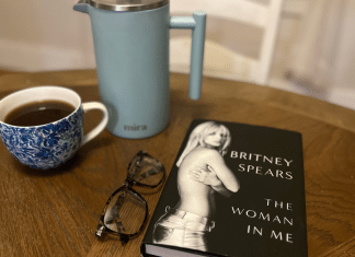 Parenting Dos and Don’ts From the Britney Spears Memoir, The Woman in Me The Britney Spears memoir on a table with a French press and a cup of coffee.