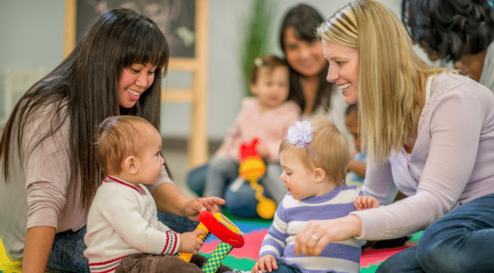 Where to Find Indoor Toddler Activities Within 30 Minutes of Burlington Two moms playing with their toddlers at a play group.