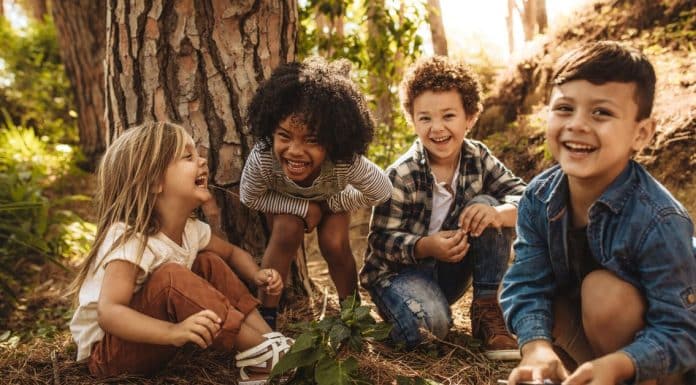 How to Play Safe: What Are the Questions to Ask Before a Drop Off Playdate? children playing outside by a tree. What are the questions to ask before a drop off playdate?