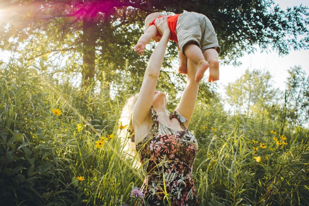 Mom holding up baby lovingly hoping to be the best parent ever for her child.