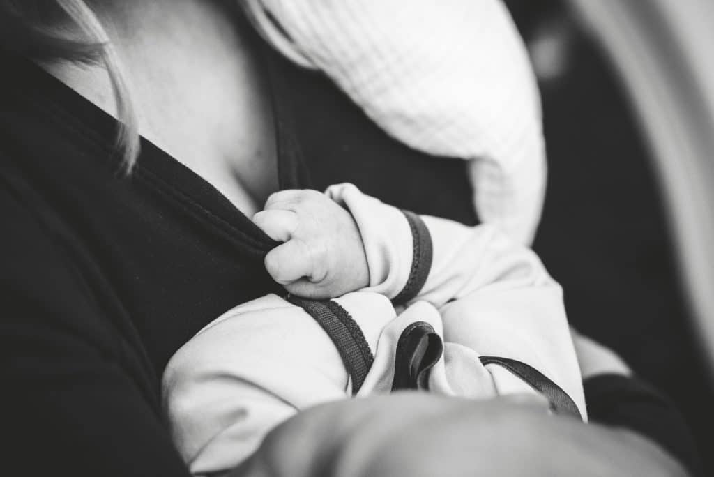 new mom cradling infant