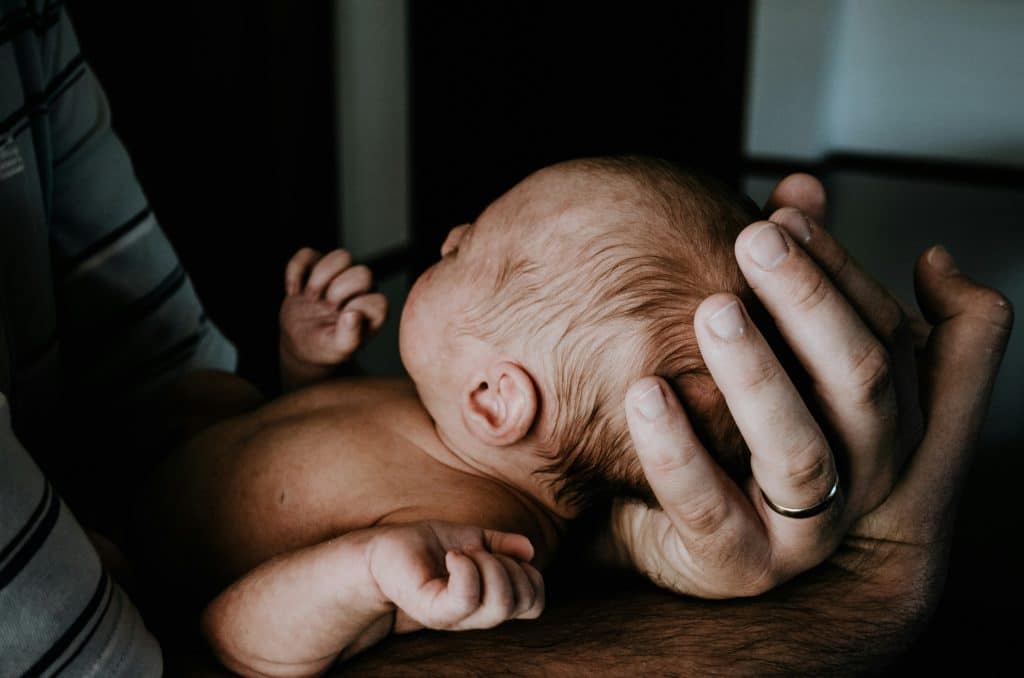New mom cradling infant's head