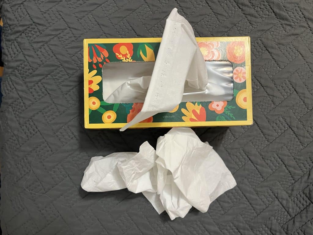 box of tissues on a comforter
