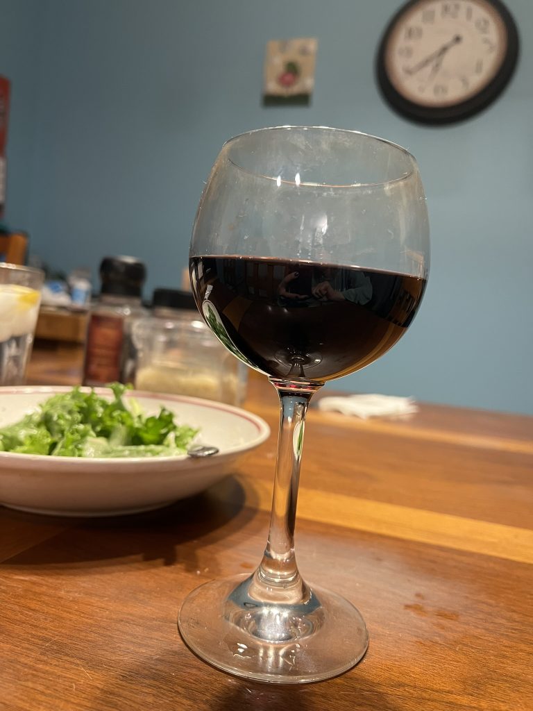 Glass of red wine with a salad