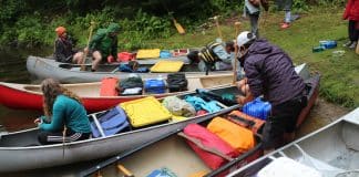 Water Wanderings Wilderness Camp Ignites Lifelong Learning and Leadership Canoes are loaded to bring campers to Water Wanderings wilderness camp rustic camp site