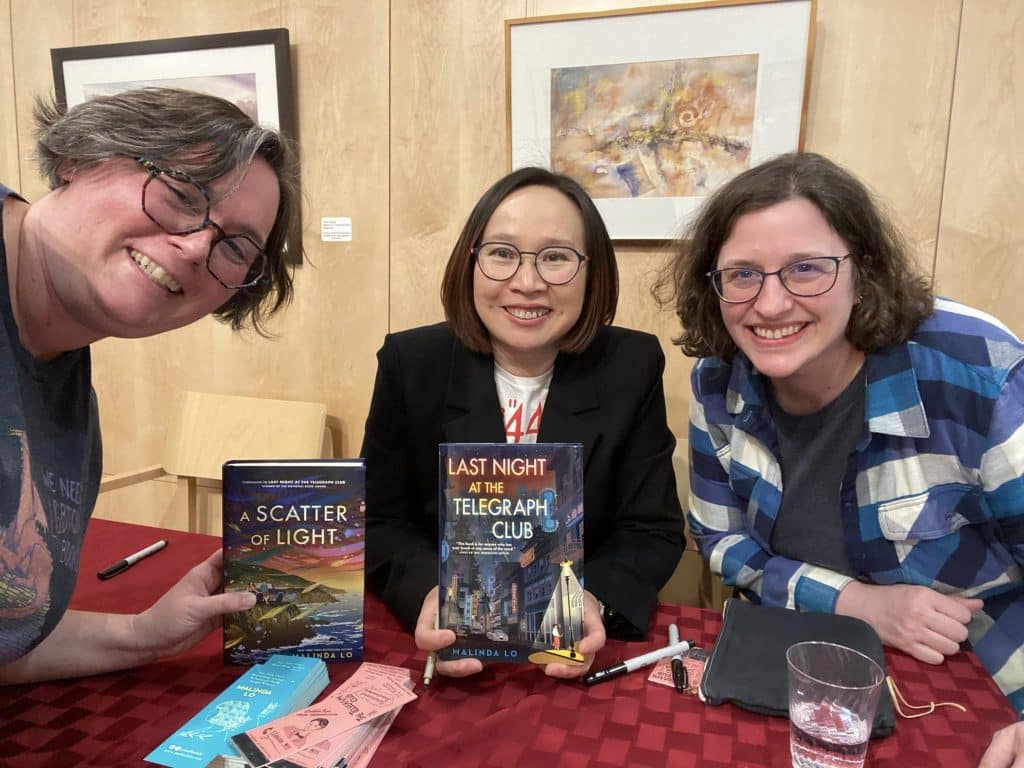 Summer (left) and her wife (right) with author Malinda Lo (center)