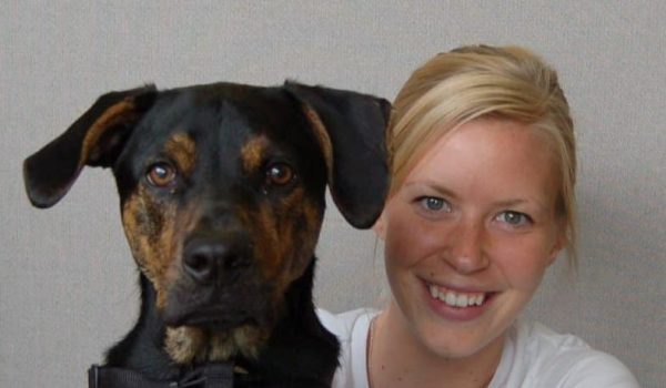 black and brown dog with blonde woman