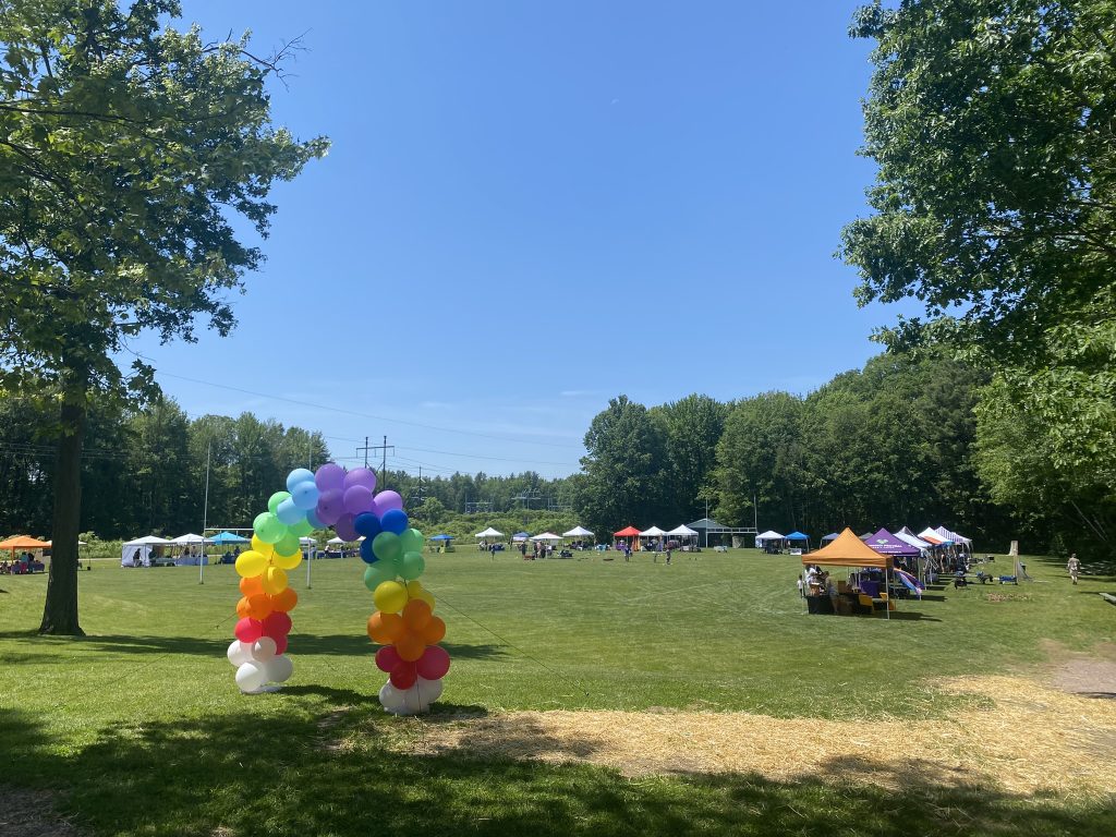 A rainbow balloon arch leads to Essex Pride.