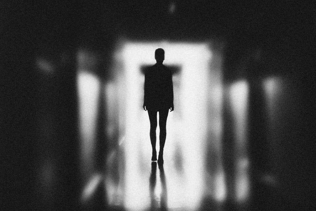 black and white image of a backlit figure