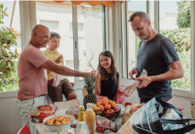 4 Easy and Delicious Dinner Recipes for Busy Families a family of four at the dining table with an assortment of food