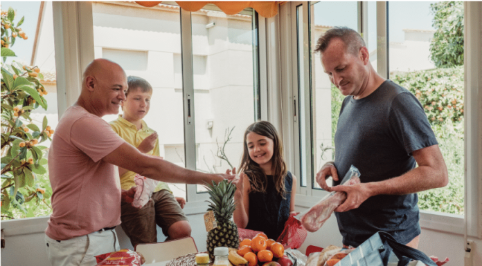 4 Easy and Delicious Dinner Recipes for Busy Families a family of four at the dining table with an assortment of food