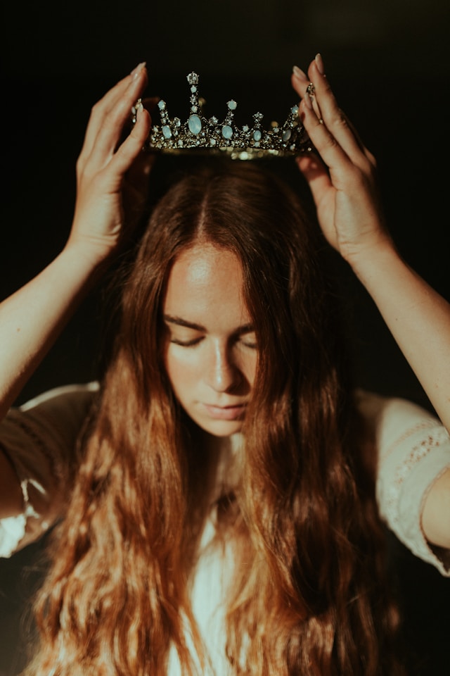 woman unleashing her mom power and putting a crown on her head.