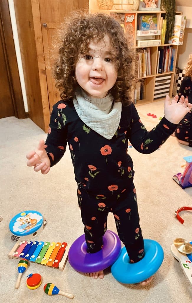 Young girl with curly hair in floral pajamas