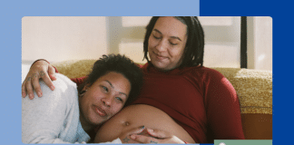 queer partners cuddling. one is pregnant.