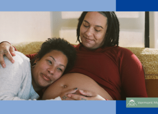 queer partners cuddling. one is pregnant.