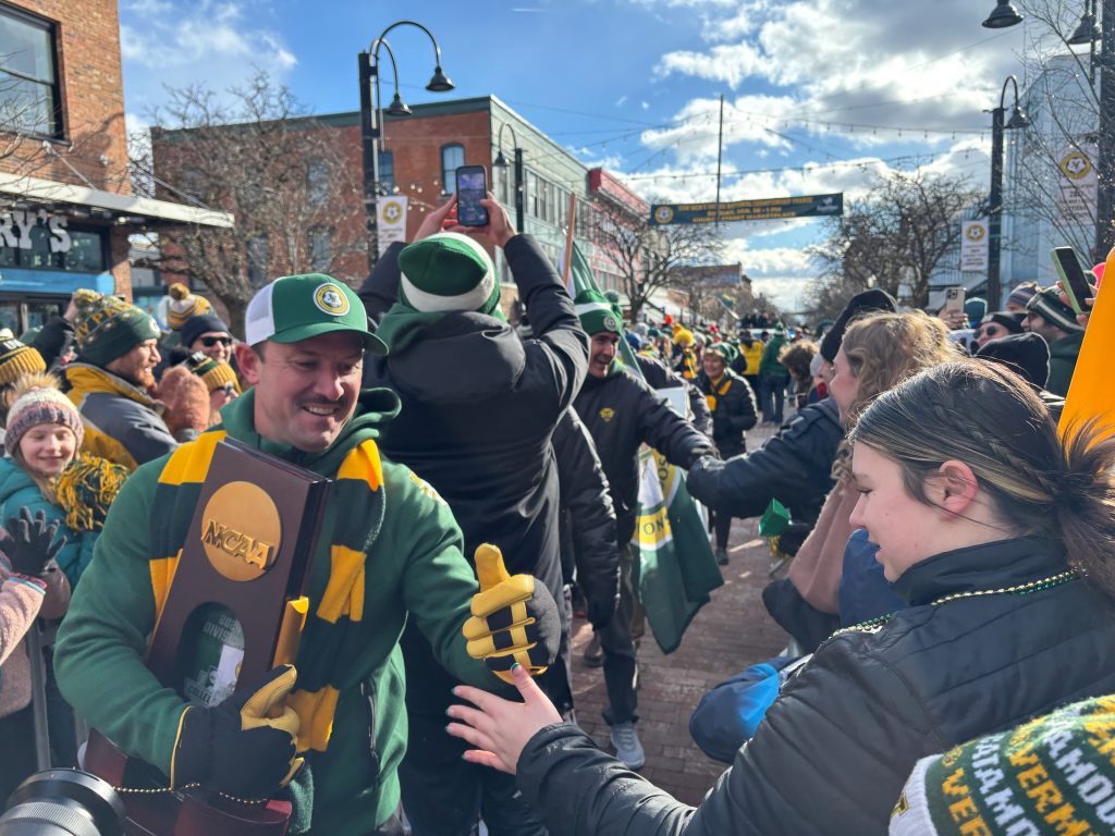 UVM men's soccer coach Rob Dow in celebration parade in downtown Burlington, Vermont