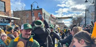 UVM men's soccer coach Rob Dow in celebration parade in downtown Burlington, Vermont
