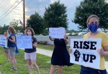 Taking Action and Maintaining Sanity in a Chaotic Political Landscape Multiple protesters holding signs along the side of the street