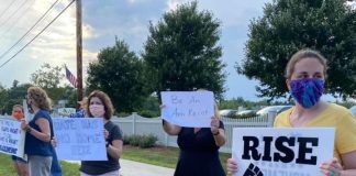 Taking Action and Maintaining Sanity in a Chaotic Political Landscape Multiple protesters holding signs along the side of the street