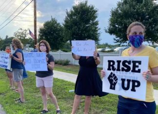 Taking Action and Maintaining Sanity in a Chaotic Political Landscape Multiple protesters holding signs along the side of the street