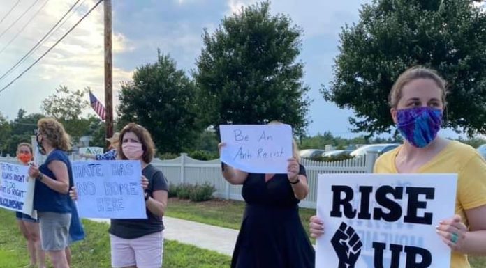 Taking Action and Maintaining Sanity in a Chaotic Political Landscape Multiple protesters holding signs along the side of the street