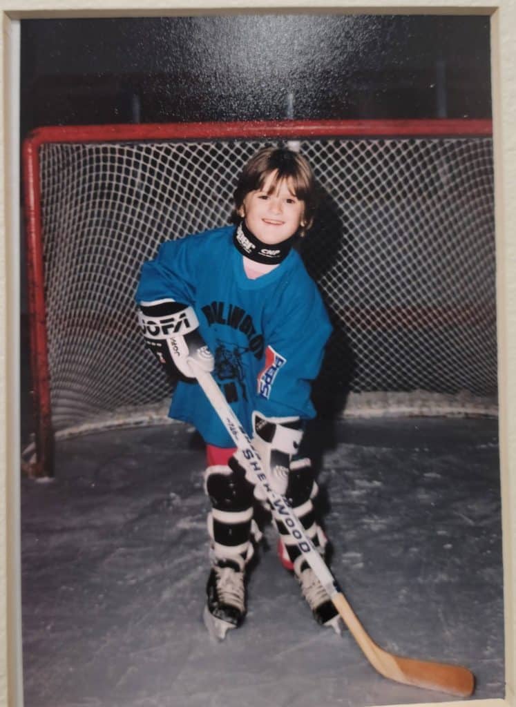 Young girl in front of a hockey goal