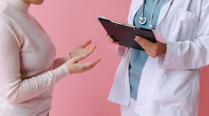 I’ve Got 99 Problems and Perimenopause is All of Them Doctor holding a clipboard talking to a woman