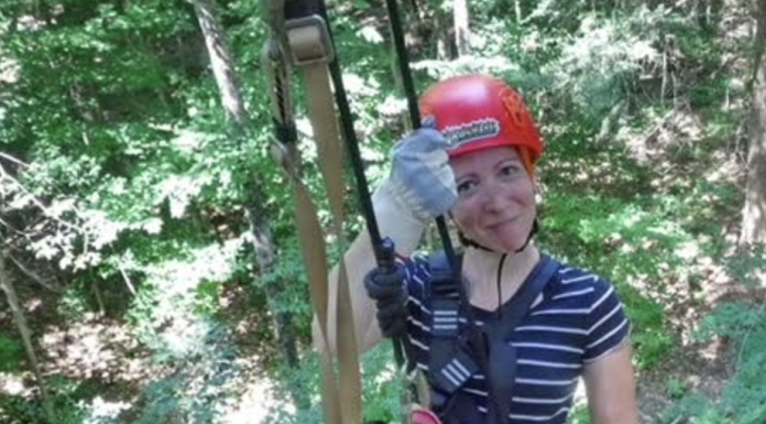 Building Confidence in Myself Outside of Motherhood woman on a zipline, smiling and wearing a red helmet