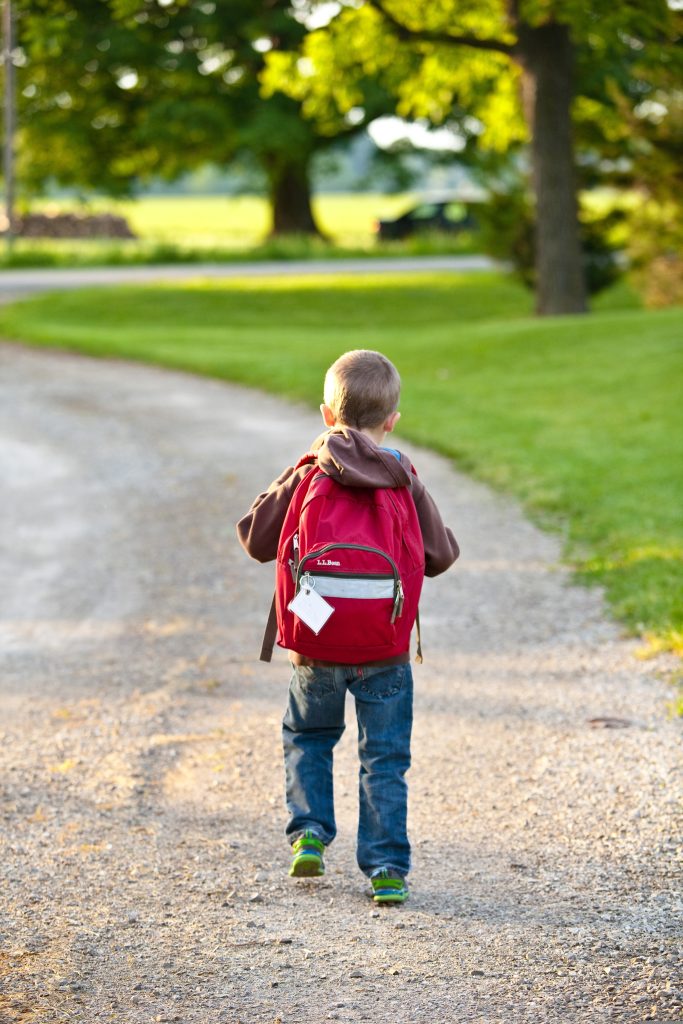 child walking down the road to go to school